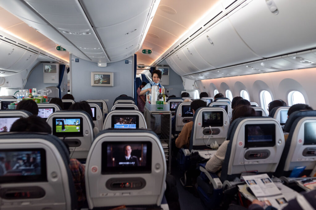 Japan ANA Airlines and Boeing 787 Dreamliner interior with People And ANA Cabin Crew Members working for passangers.