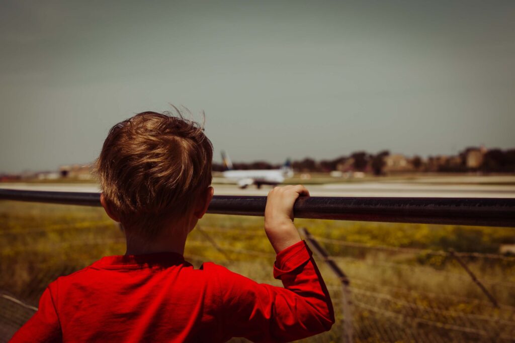 kid looking at an aeroplanejpg kid_looking_at_an_aeroplane.jpg