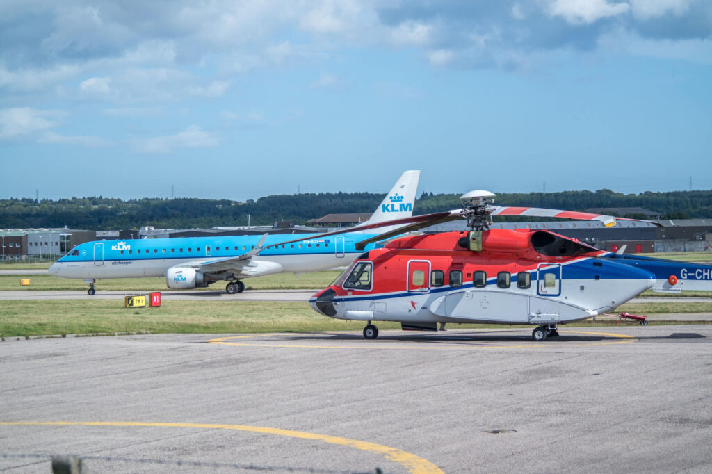 klm plane and a helicopter at abz airportjpg klm_plane_and_a_helicopter_at_abz_airport.jpg
