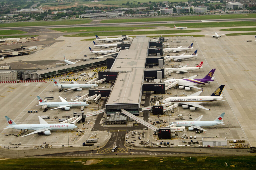 Aerial view of planes at Terminal 2 of London Heathrow Airport on a cloudy day. Airlines using this terminal include Air Canada, Singapore Airlines and United Airlines.