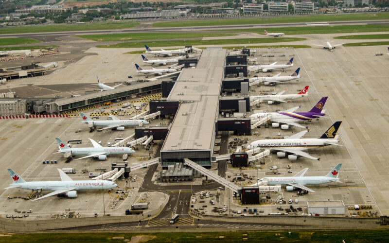 Aerial view of planes at Terminal 2 of London Heathrow Airport on a cloudy day. Airlines using this terminal include Air Canada, Singapore Airlines and United Airlines.