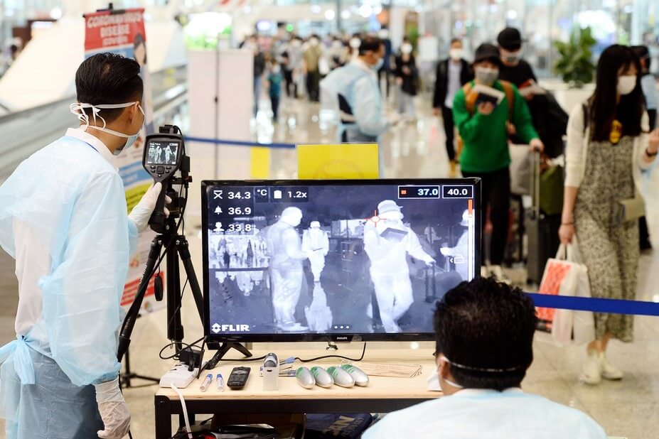 malaysian_health_ministry_officers_use_a_thermal_scanner_to_check_the_temperatures_of_passengers_arriving_at_the_kuala_lumpur_international_airport.-1.jpg