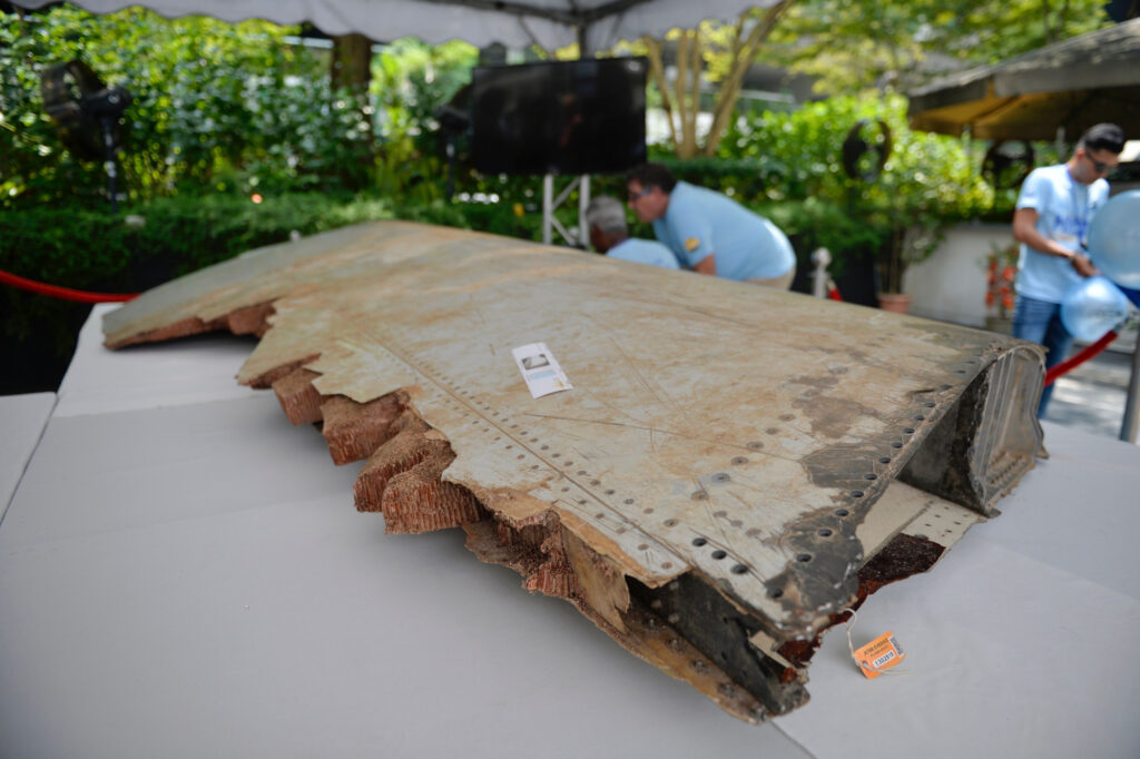 A piece of debris belonging to flight MH370 is displayed during the remembrance ceremony