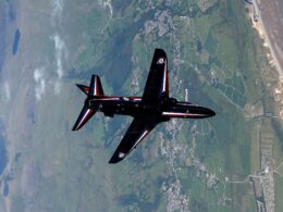 A Royal Navy BAE Systems Hawk T1 jet banks over the British countryside