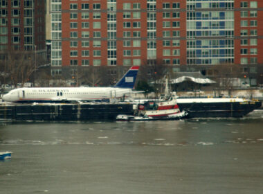US Airways Flight 1549 resting on a barge next to Battery Park City, after being raised out of the Hudson River.