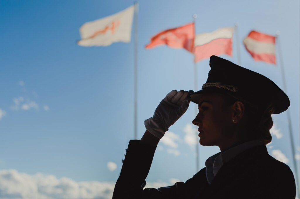 silhouette_of_a_female_pilot_with_flags_in_the_background.jpg