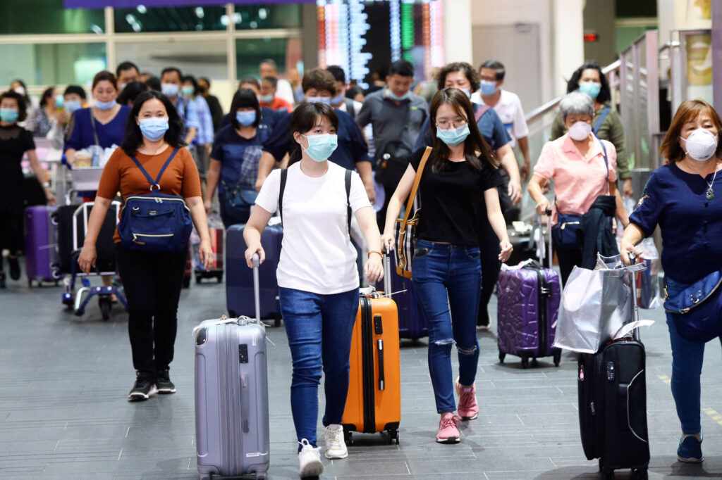 travelers_wearing_masks_at_kuala_lumpur_airport.jpg