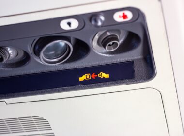 Attention announcement for passengers fasten your seat belt sign on information board inside the airplane cabin